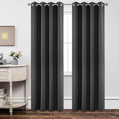 Dark grey blackout curtain panels hung either side of a window